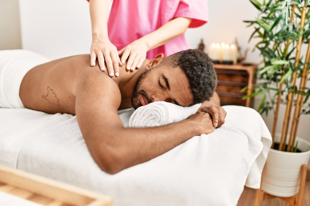 Black man getting a relaxing massage at Blu Bliss Spa in Pembroke Pines FL South Florida